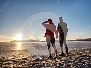 Fitnes couple man and woman. Winter landscape with sun