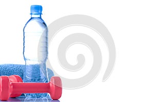 Fitnes symbols - blue dumbbells, a bottle of water and a towel. The concept of a healthy lifestyle