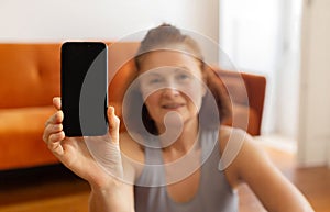 Fitness App. Smiling Senior Woman Showing Blank Smartphone With Black Screen