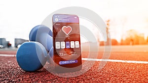 Fitness application. Smartphone screen with sport gym or fitness health mobile application on dumbbell background