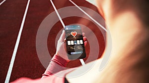 Fitness application. Smartphone screen with sport gym or fitness health mobile application. Girl holding online fitness