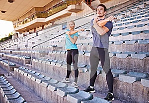 Fitness, arms and couple stretching at stadium for race, marathon or competition training for health. Sports, energy and