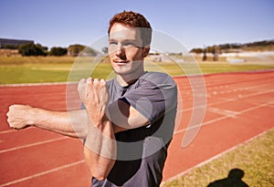 Fitness, arms and man runner stretching in stadium for race, marathon or competition training for health. Sports, vision