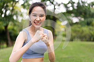 Fitness Asian Girl in tight sportswear doing exercises and punching boxing footwork cardio exercise in park. Female student boxer