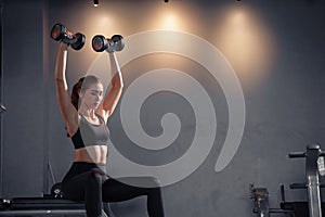 Fitness asian woman doing exercise and lifting dumbbells weights at sport gym