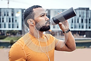 Fitness, athlete and man drinking water in the city after running for exercise or marathon training. Sports, hydration