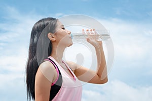 Athlete woman drinking water after work out exercising