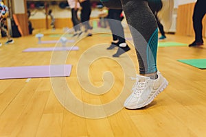 Fitness athletes foot close-up. Healthy lifestyle and sport concepts. Woman in fashionable sportswear is doing exercise.