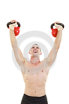 fitness athletic man holding and lifting high up red kettlebells weights