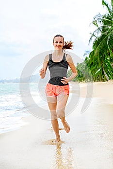 Fitness. Athletic Woman Running On Beach. Sports, Exercising, He