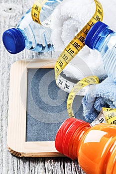 Fitness background with water bottles and towels