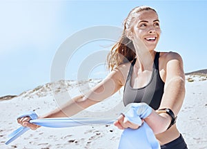 Fitness, beach and band stretch with a woman using a resistance band for arm stretching by the ocean. Rubber, warmup and