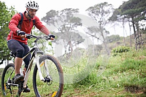 Fitness, bike and man cycling in forest for adventure, discovery or off road sports hobby. Exercise, health and wellness