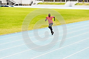 Fitness, black man and running on race track for athletics, sprint challenge or competition training in stadium. Runner