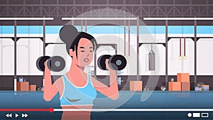 Fitness blogger doing exercises with dumbbells sportswoman vlogger recording online video for blog healthy lifestyle