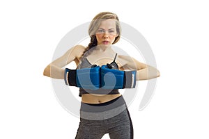 fitness blonde posing in a Studio in boxing gloves