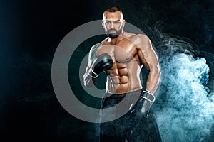 Fitness and boxing concept. Boxer, man fighting or posing in gloves on black background. Individual sports recreation.