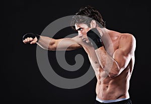 Fitness, boxing and man punching in studio for exercise, challenge or competition training for gym. Power, muscle or