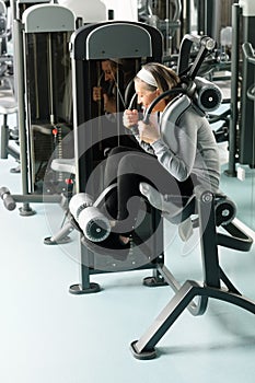 Fitness center senior woman exercise abs muscles