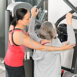 Fitness center trainer senior woman exercise