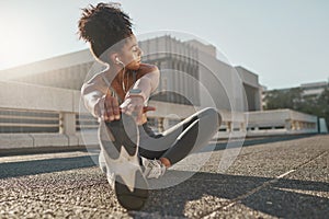 Fitness, city and woman stretching her legs in the street before a cardio workout, running or training. Sports, health