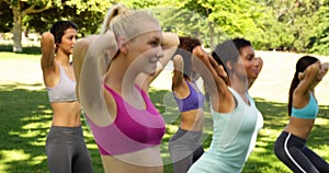 Fitness class doing squats in unison