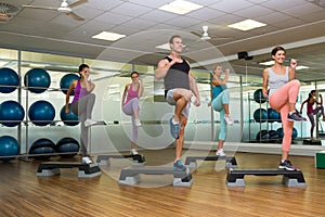 Fitness class doing step aerobics