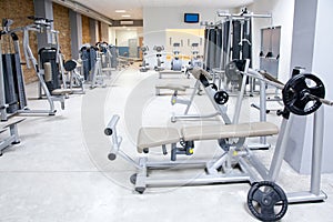 Fitness club gym with sport equipment interior