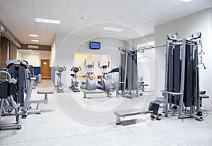 Fitness club gym with sport equipment interior