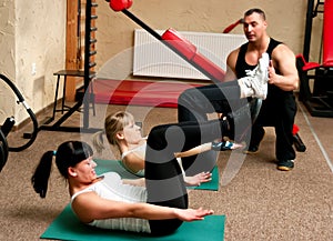 Fitness club women with trainer
