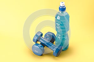 Fitness concept with dumbbells and bottle/blue dumbbells and bot