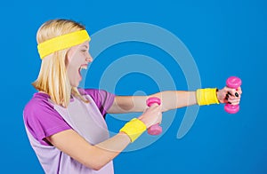 Fitness concept. Girl exercising with dumbbell. Fitness instructor hold little dumbbell blue background. How to get