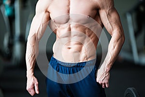 Fitness concept. Muscular and torso of young man having perfect abs, bicep and chest. Male hunk with athletic body.