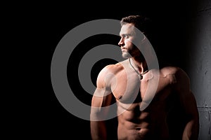 Fitness concept. Muscular and torso of young man having perfect abs, bicep and chest. Male hunk with athletic body.