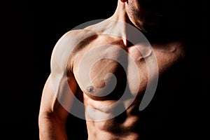 Fitness concept. Muscular and torso of young man having perfect abs, bicep and chest. Male hunk with athletic body.