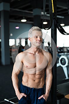 Fitness concept. Muscular and torso of young man having perfect six pack abs, bicep and chest. Bodybuilder with