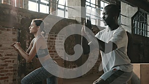 Fitness. Couple doing leg lunge exercise workout at sport gym