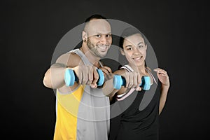 Fitness couple with dumbbells