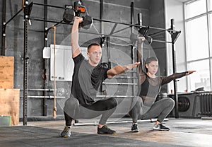 Fitness couple in gym working out together.