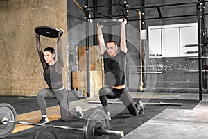 Fitness couple in gym working out together. Sporty couple