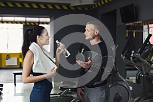 Fitness couple having break at gym