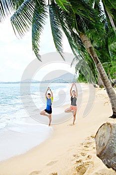 Fitness. Couple Practicing Yoga On Beach. Exercising. Sports. St