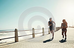 Fitness, couple and running for exercise by beach in workout, training and cardio in South Africa outdoors. Active man