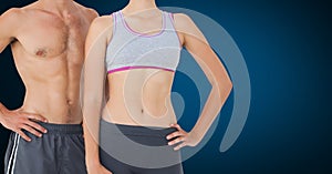 Fitness couple standing against blue background