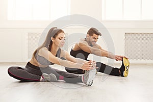 Fitness couple at stretching training indoors