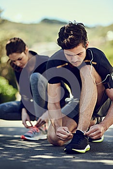 Fitness, couple and tie shoes ready for workout, exercise and training for physical strength. Runners, man and woman