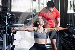 Fitness couple train with Dumbbells in gym