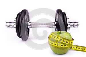 Fitness And Diet Concept - With Barbell, Apple And Tape Measure