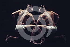 Fitness dieting and flexibility in acrobatics. Twins men with muscular body in pose. Circus gymnasts at pilates or yoga