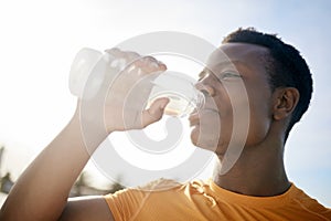 Fitness, drink and black man with water bottle in exercise, training or outdoor cardio workout. Athlete, drinking and